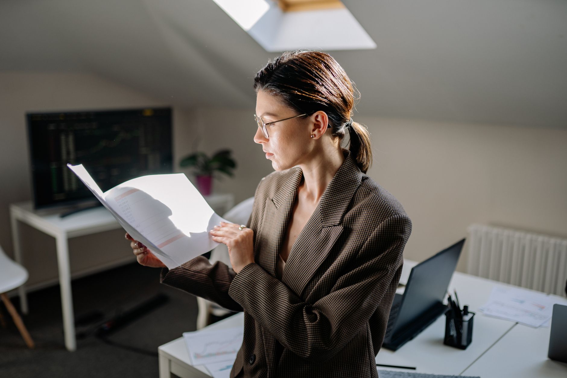 A professional reviewing documents at an office desk